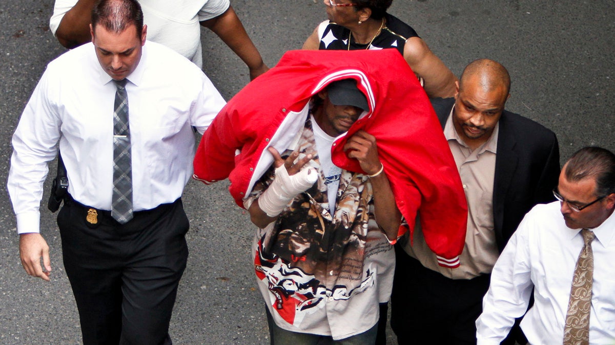  Sean Benschop, center, with red jacket over his head, walks with investigators to the Philadelphia Police Department's Central Detectives Division in 2013.Benschop's attorney says he will plead guilty Tuesday to charges including involuntary manslaughter and causing a catastrophe. (AP file photo) 