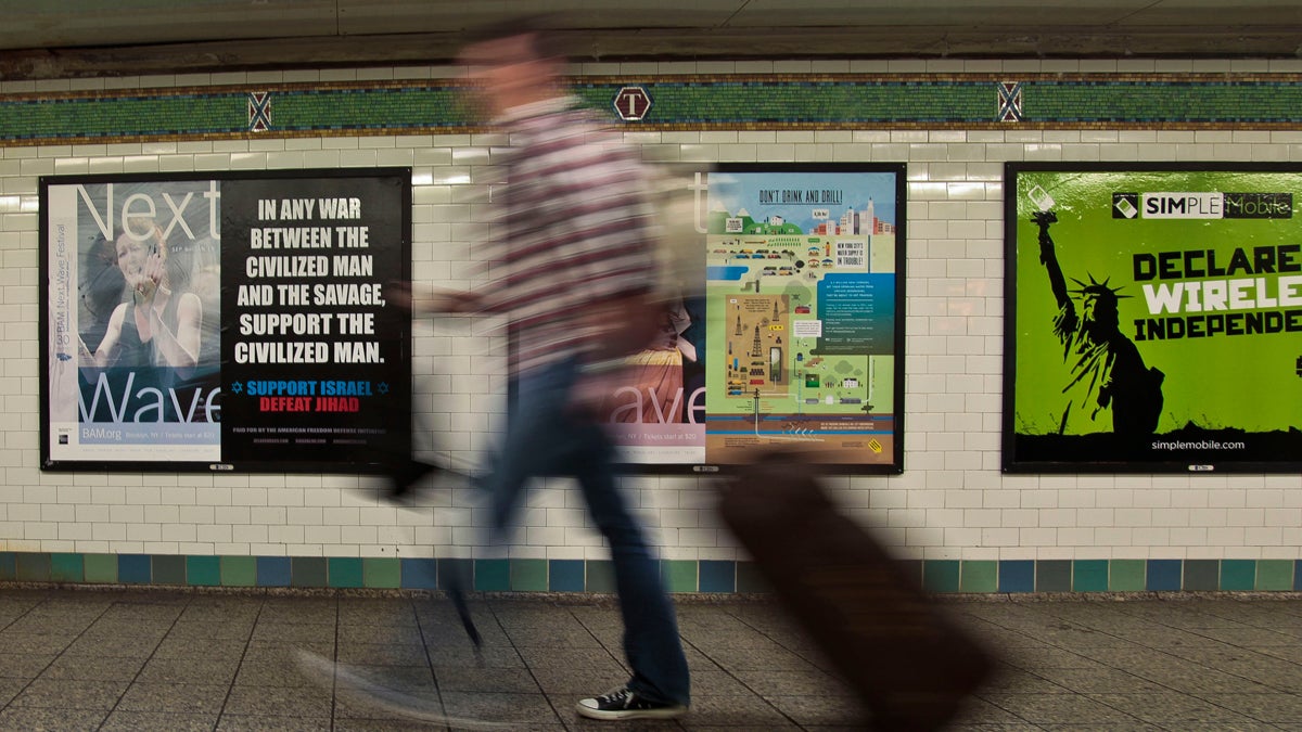  A commuter walks past an anti-Muslim poster in New York's Times Square subway station. The MTA initially refused to run the ad saying it was 'demeaning.' But a federal judge ruled that it is protected speech under the First Amendment of the U.S. Constitution. (Bebeto Matthews/AP Photo) 