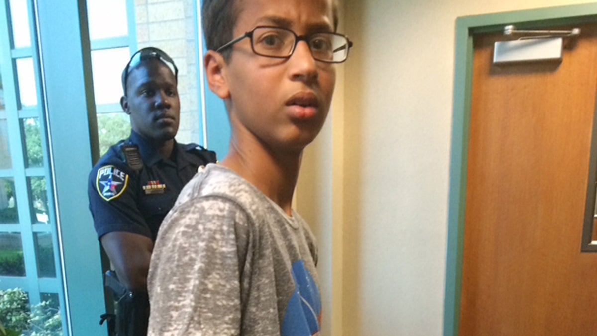 In this Sept. 14, 2015 photo provided by Eyman Mohamed, her brother Ahmed Mohamed stands in handcuffs at Irving police department in Irving, Texas. The 14-year-old Muslim boy became a sensation on social media Wednesday, Sept. 16 and got an invitation to the White House after word spread that he had been placed in handcuffs and suspended for coming to class with a homemade clock that school officials thought resembled a bomb. (Eyman Mohamed via AP) 
