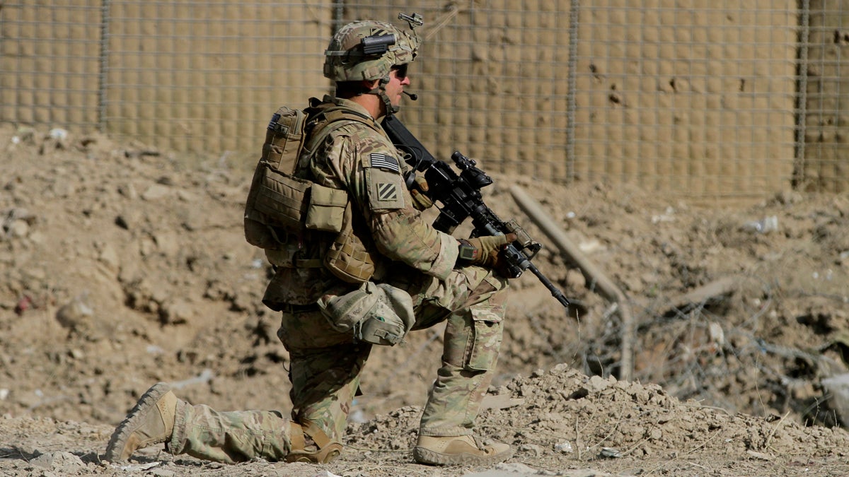  An American soldier, part of the NATO-led International Security Assistance Force (ISAF), kneels down at the site of a suicide attack in Wardak Province, east of Kabul, Afghanistan, Sunday, Sept. 8, 2013. Taliban militants detonated a car bomb outside an Afghan intelligence office near the capital Sunday and then tried to attack it on foot with guns, officials and the insurgent group said. At least four soldiers guarding the compound were killed and six insurgents died in the assault, officials said. (Ahmad Jamshid/AP Photo) 