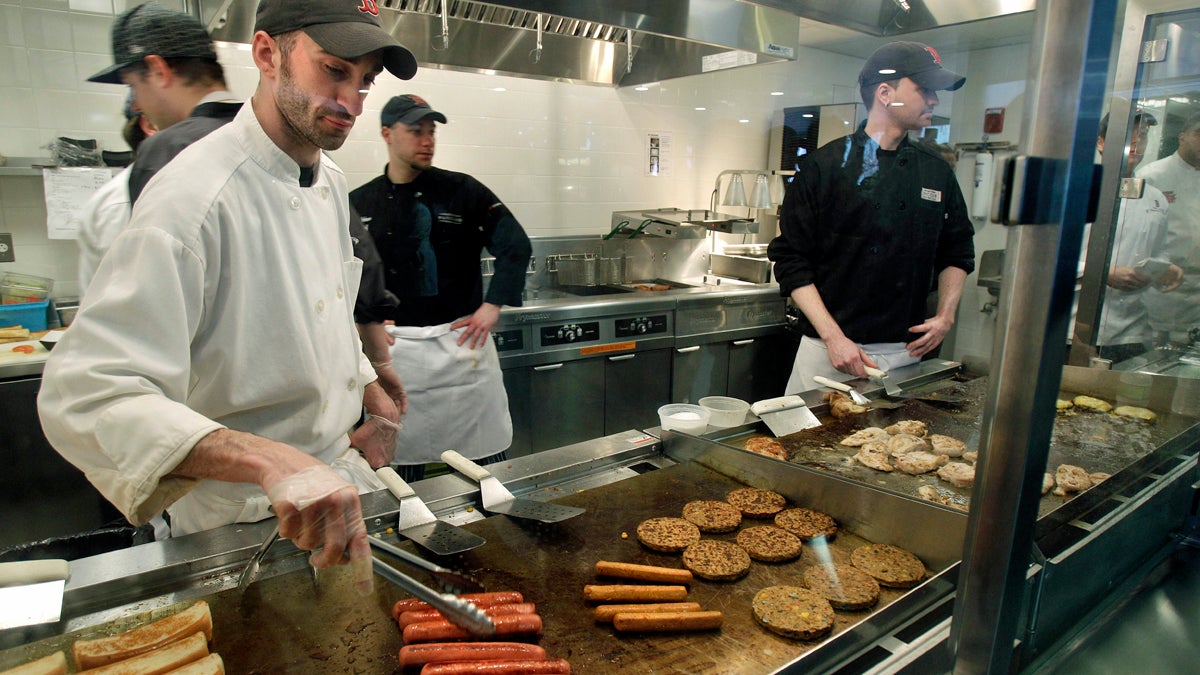  Aramark employees grill hotdogs, hamburgers and chicken. (Elise Amendola/AP Photo) 