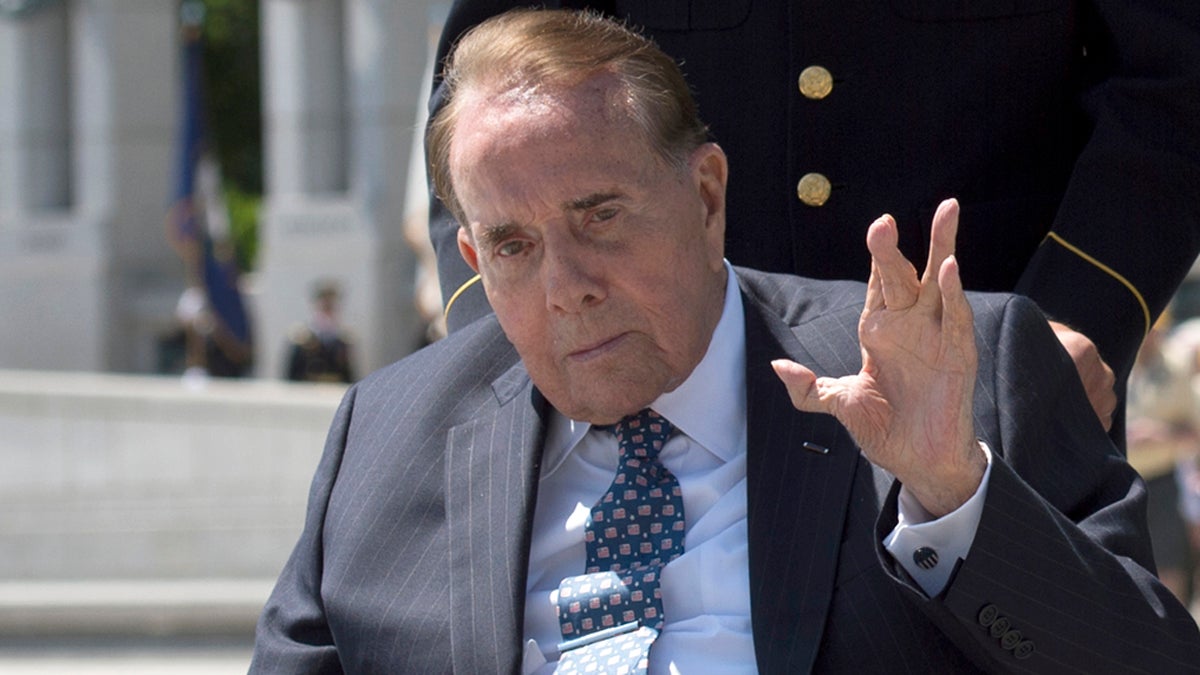  WWII veteran and former Senate Majority Leader Bob Dole waves after taking part in a wreath laying ceremony at a 10th anniversary ceremony for the WWII Memorial in Washington, Saturday, May 24, 2014. (Molly Riley/AP Photo) 