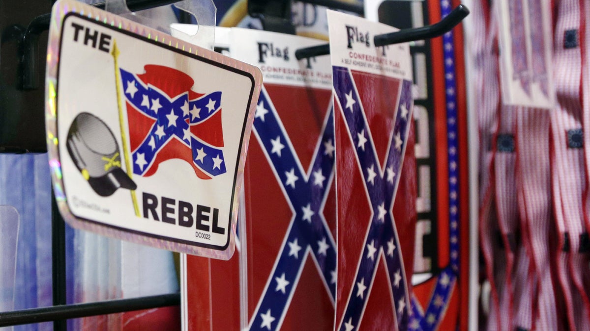 Small Confederate flags are displayed on a shelf at Arkansas Flag and Banner in Little Rock