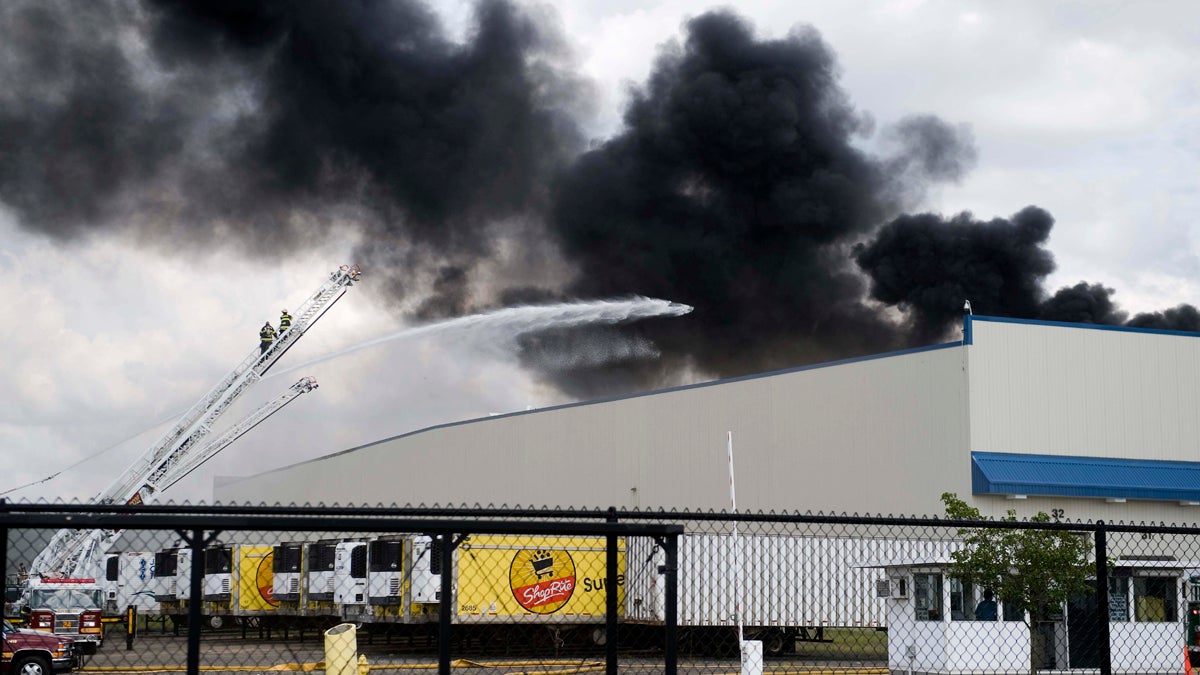  Firefighters work to contain a multi-alarm blaze that reportedly started with a refrigeration unit on the roof at the Dietz and Watson warehouse on Coopertown Road in Delanco on Sunday, September 1, 2013 (Camden Courier-Post, Jodi Samsel/AP Photo) 