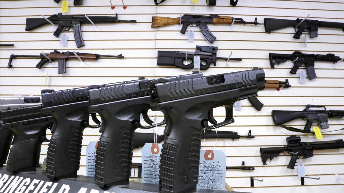  In this Jan. 16, 2013 file photo, assault weapons and hand guns are seen for sale (Seth Perlman/AP File Photo) 