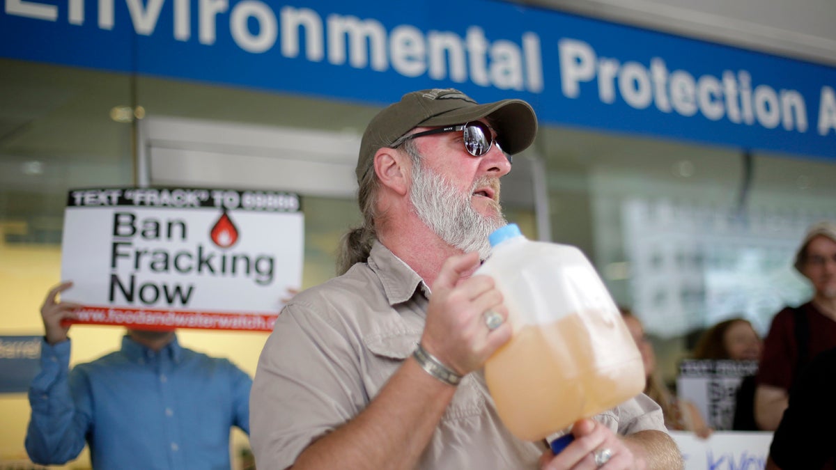 Ray Kemble of Dimock, displays a jug of what he identifies as his contaminated well water in this August 2013 file photo (Matt Rourke/AP Photo) 