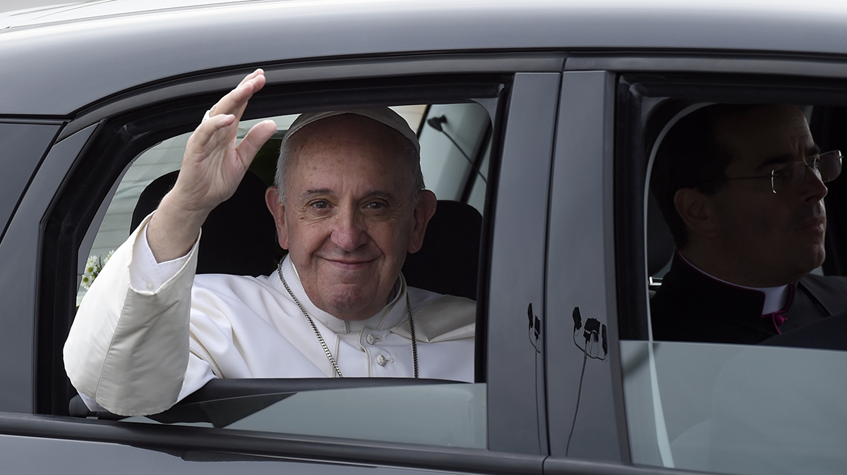 Pope Francis waves from inside his car after arriving at Philadelphia International Airport in Philadelphia, Saturday, Sept. 26, 2015. The Pope will spend the last two of his six days in the U.S. in Philadelphia as the star attraction at the World Meeting of Families, a conference for more than 18,000 people from around the world that has been underway as the pope traveled to Washington and New York. (Susan Walsh/AP Photo)  
