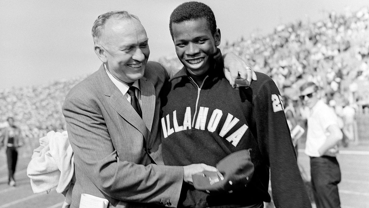  In this June 24, 1961, file photo, Villanova sprinter Frank Budd (right) is congratulated by coach James Elliott after winning the 100-yard dash at the National AAU track and field championships in New York, with a world record time of 9.2 seconds. Budd, an Olympic sprinter and former 100-meter dash world record holder, died Tuesday, April 29, 2014, Villanova University said. He was 74. (AP Photo/File) 