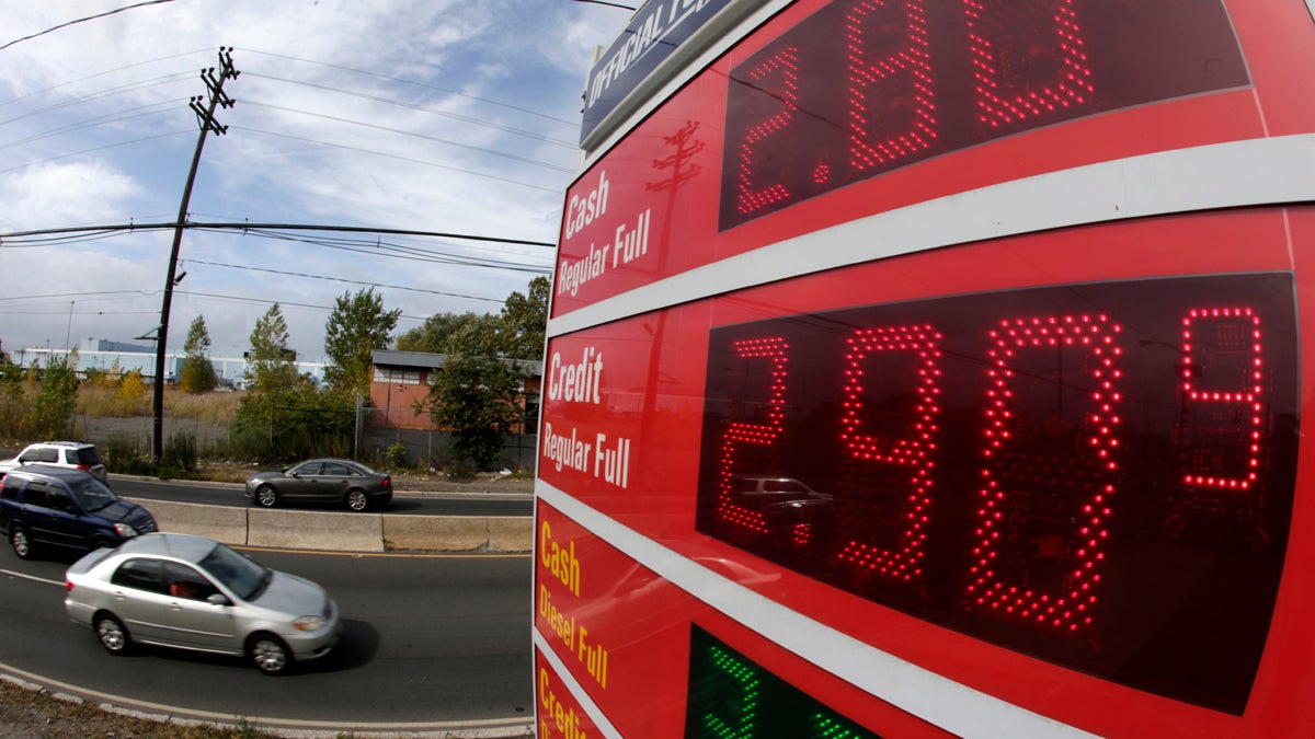 CORRECTION Oil Prices Global Impact Gas prices below $3 dollars are displayed at a gas station, Wednesday, Oct. 15, 2014, in Jersey City, N.J. (Julio Cortez/AP Photo)