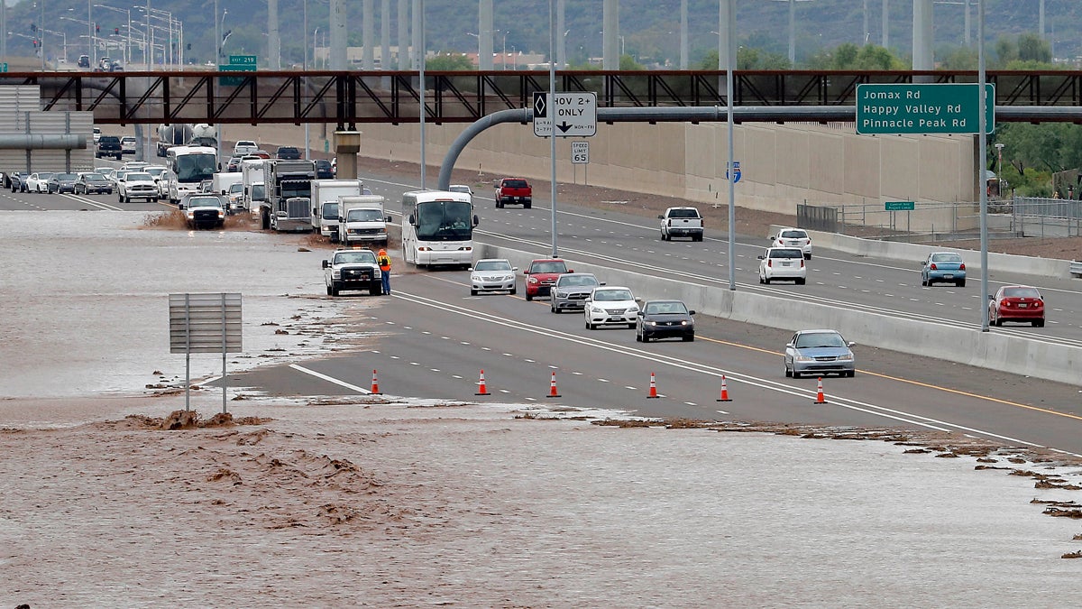  This Aug. 19, 2014 file photo shows flash flood waters from the overrun Skunk Creek flood I-10 in northwestern Phoenix. Global warming is here, human-caused and can already be considered dangerous, a draft of a new international science report says, warning that it is increasingly likely that climate change could be irreversible. The United Nations’ Intergovernmental Panel on Climate Change on Monday sent governments a final draft of its synthesis report, which combines three earlier, gigantic documents by the Nobel Prize-winning group. There is little in the report, that wasn’t in the other more-detailed versions, but the language is more stark and the report attempts to paint a bigger picture of the problem caused by the burning of fossil fuels, such as coal, oil and gas. (Matt York/AP Photo, file) 