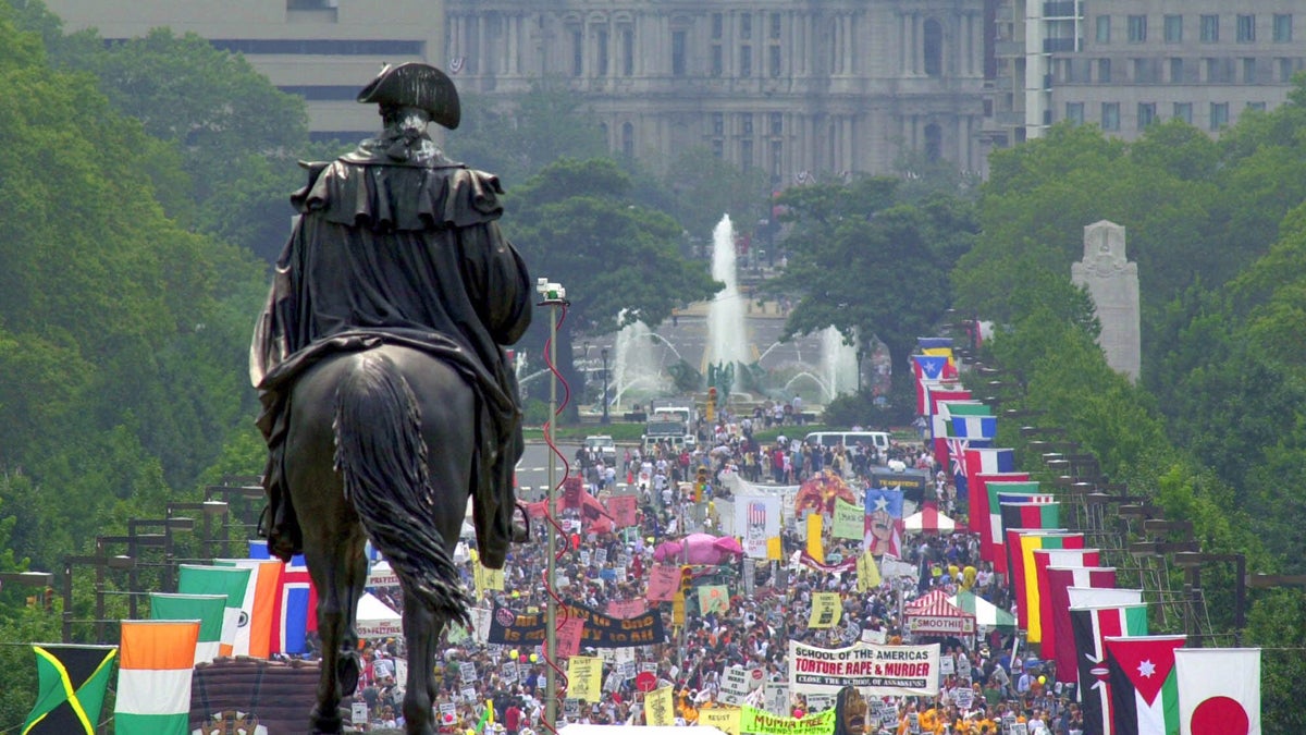  Overlooked by a statue of George Washington on a horse, protesters march up Ben Franklin Blvd., toward the Philadelphia Museum of Art, Sunday, July 30, 2000, on the eve before the Republican National Convention. (William Wilson Lewis III/AP Photo) 