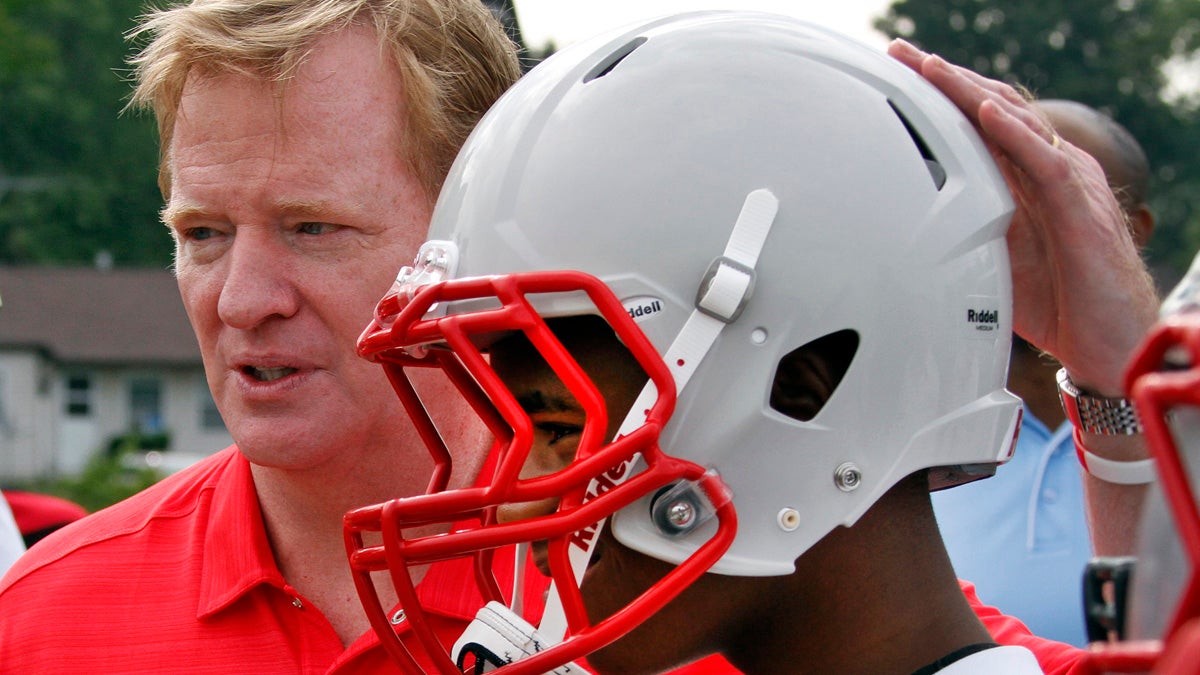  In this 2012 photo, NFL commissioner Roger Goodell, left, poses with a youth football player from a low income family who are among thousands nationwide to benefit from a youth safety and helmet replacement program, partially sponsored by the NFL. (Gene J. Puskar/AP Photo, file) 