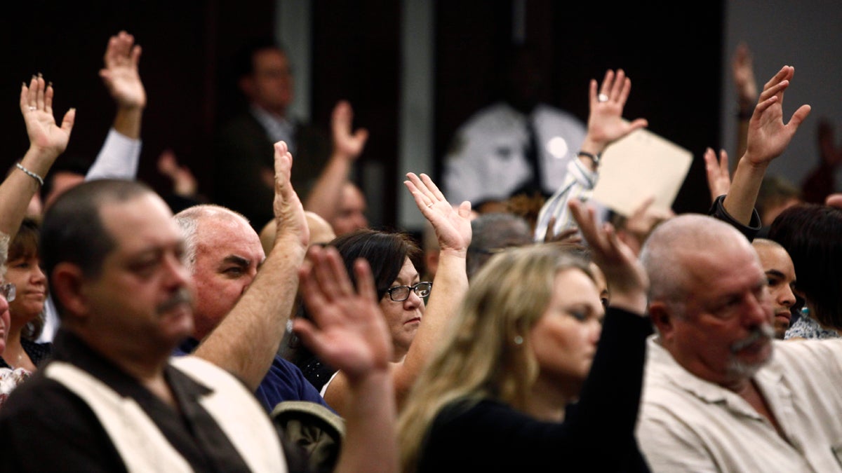  People raise their hands to affirm they would attend jury duty in January 2012 in response to Circuit Judge Gregory Holder, as he addresses residents who did not show up for jury duty in Tampa, Fla. The group of 246 people got a stern lecture on responsibility and a civics lessons from Judge Holder. (St. Petersburg Times, Skip O' Rourke/AP Photo, pool) 