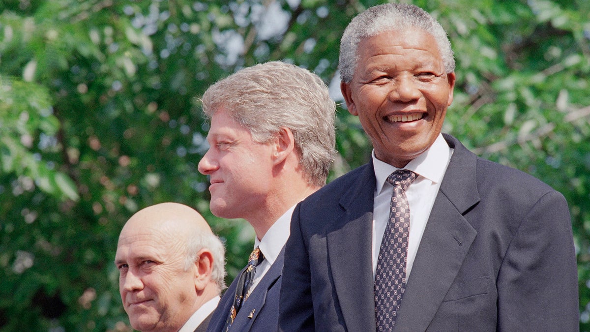  From left, F.W. de Klerk, President Bill Clinton, and Nelson Mandela appear at ceremonies honoring the two South African leaders with the Philadelphia Liberty Medal at Independence Hall in Philadelphia Sunday, July 4, 1993. (Greg Gibson/AP Photo) 