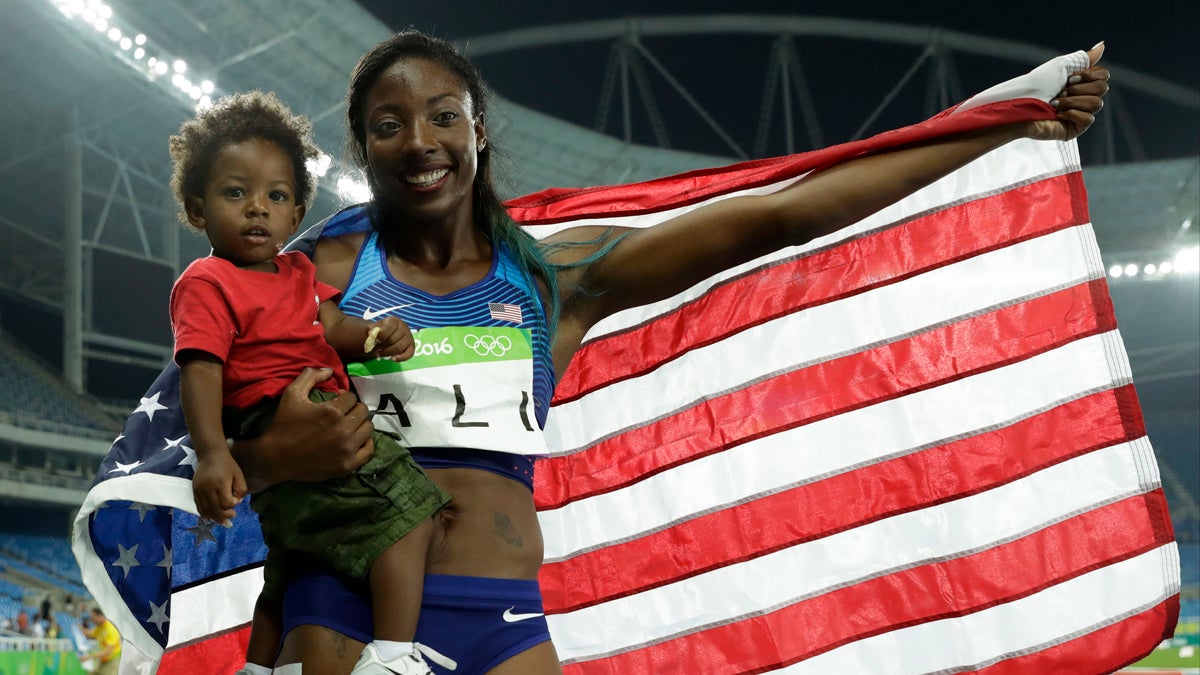 United States' silver medal winner Nia Ali poses with her 15-months old son Titus after the women's 100-meter hurdles final
