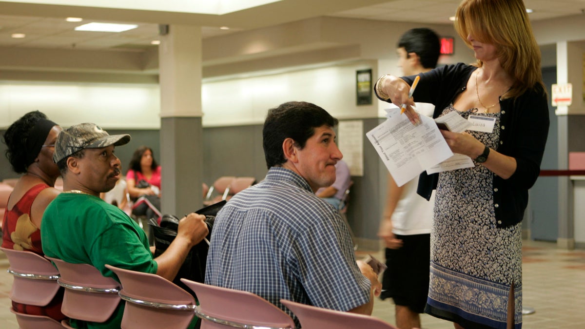 People wait at the Motor Vehicle Center in Wayne