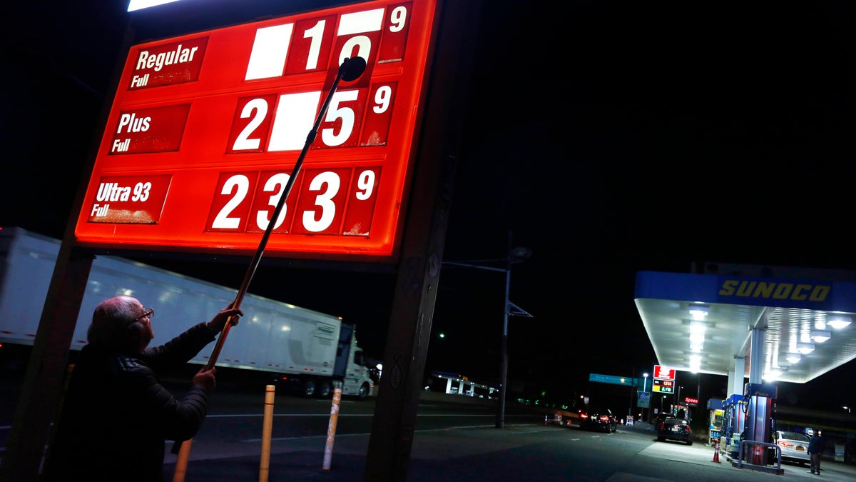 Leon Balagula changes the price for the gasoline at his Sunoco station in the early Tuesday morning in Fort Lee