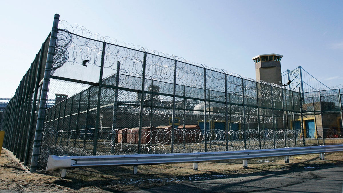 A guard tower and razor wire at New Jersey Department of Corrections Riverfront State Prison are seen in Camden, N.J., not far from the span, left, of the Benjamin Franklin bridge that crosses the Delaware River to Philadelphia.