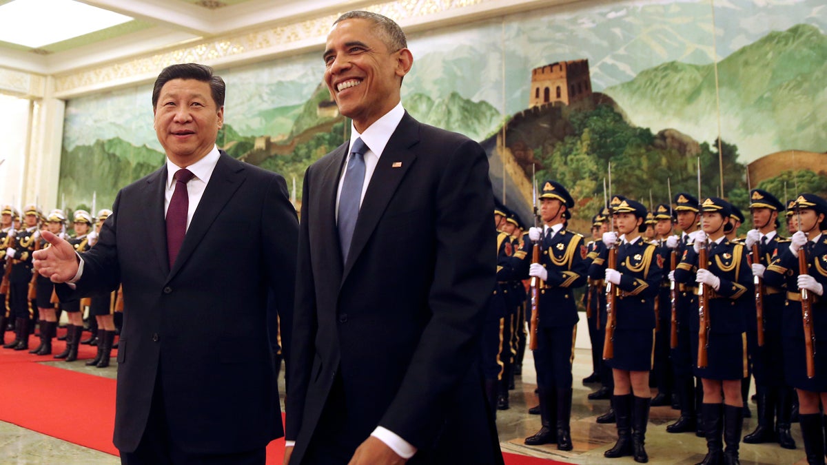  U.S. President Barack Obama smiles as he walks with Chinese President Xi Jinping during a welcome ceremony at the Great Hall of the People in Beijing Wednesday, Nov. 12, 2014. (Andy Wong/AP Photo) 