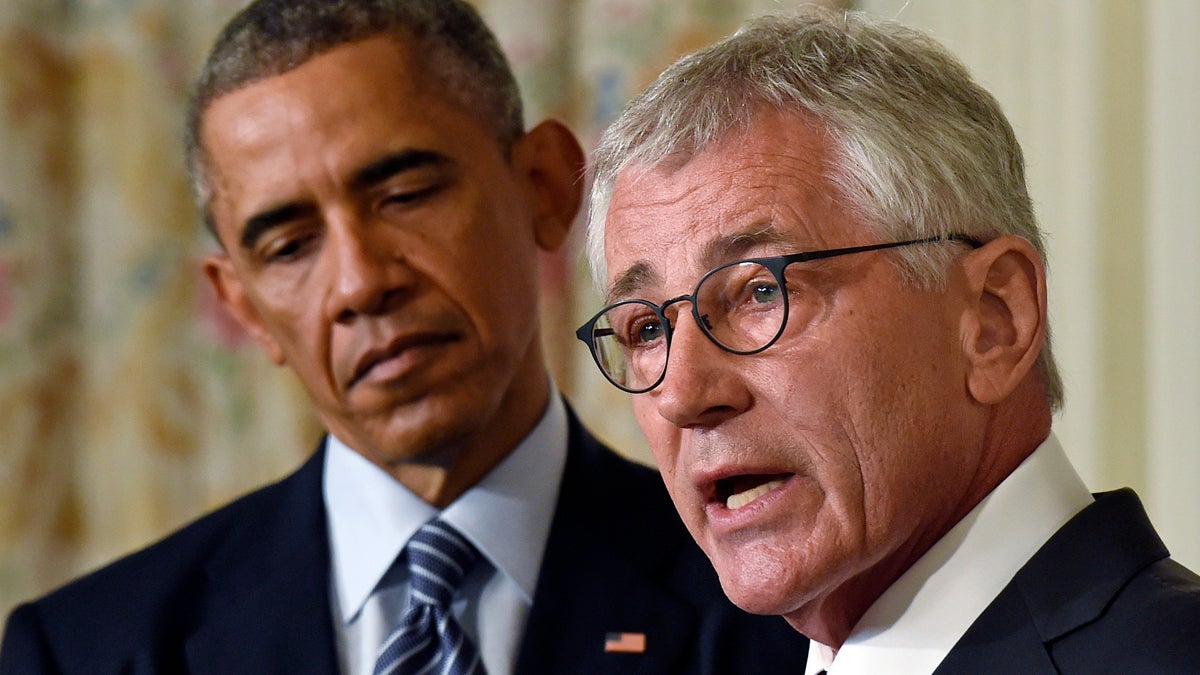  President Barack Obama listens as Defense Secretary Chuck Hagel talks about his resignation during an event in the State Dining Room of the White House in Washington, Monday, Nov. 24, 2014. Hagel is stepping down under pressure from Obama's Cabinet, senior administration officials said Monday, following a tenure in which he has struggled to break through the White House's insular foreign policy team. (Susan Walsh/AP Photo) 