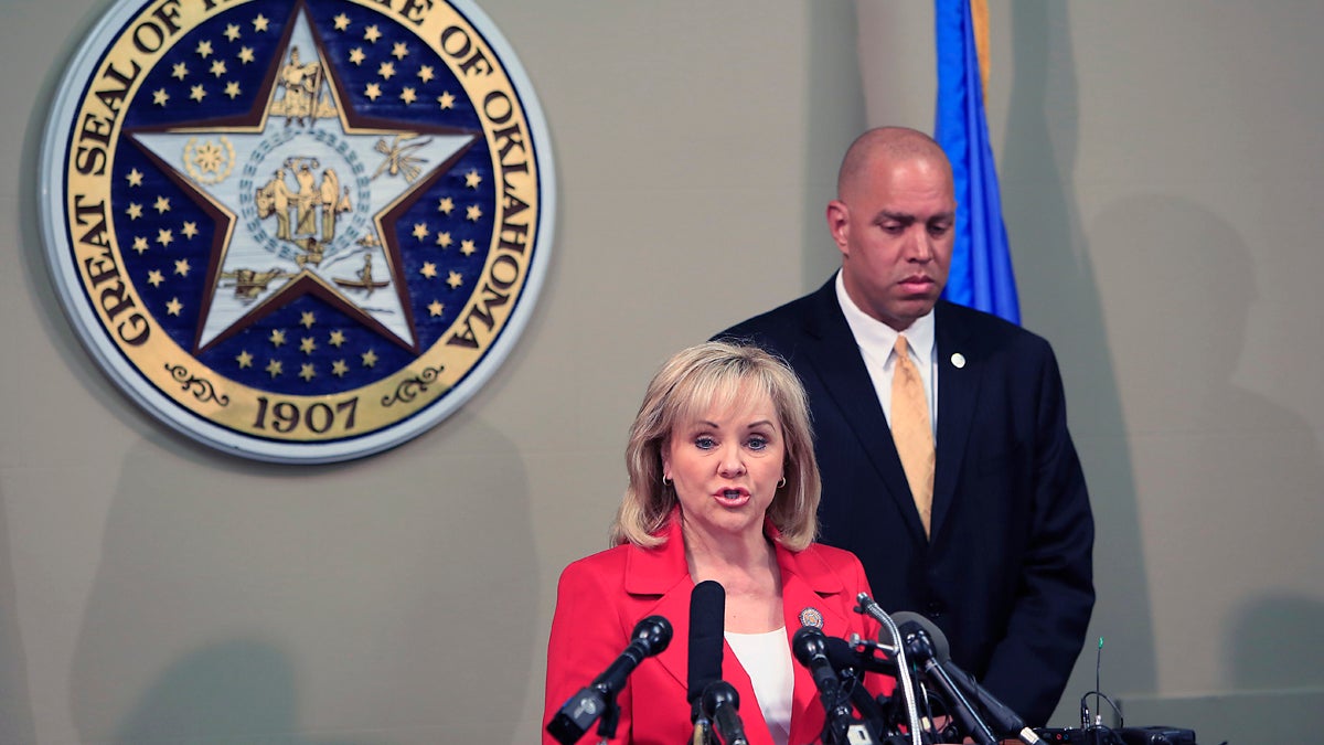  In this April 30, 2014 file photo, Oklahoma Gov. Mary Fallin, front, issues a statement to the media on the Execution of Clayton Lockett as Oklahoma Secretary of Safety and Security Michael C. Thompson, back, listens from the Oklahoma State Capitol in Oklahoma City. The botched execution of Lockett, and the gruesome details of him writhing and moaning before dying of a heart attack, has outraged death penalty opponents, raised the potential of more court challenges and received international attention. (Alonzo Adams/AP Photo, file) 
