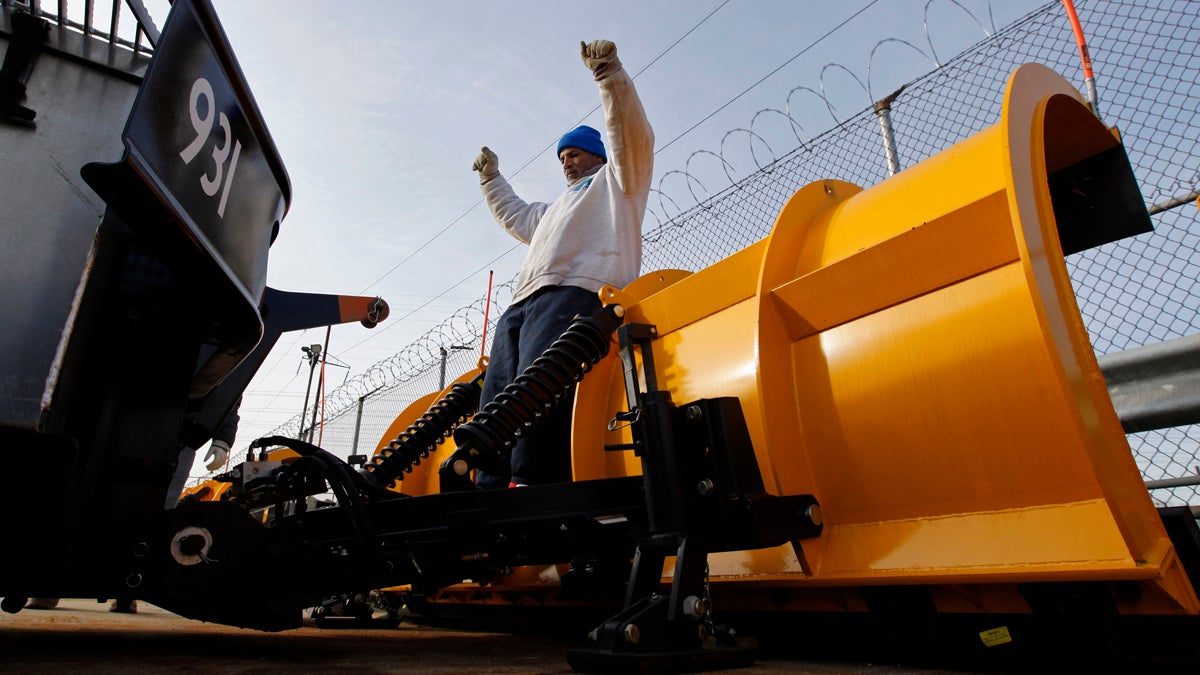  A PennDOT worker directs a driver connecting a truck to a snow plow in Philadelphia in 2009. (Matt Rourke/AP Photo) 