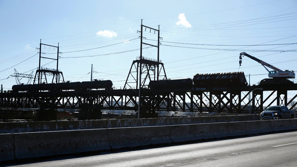  In this Jan. 24, 2014, photo, railroad crews transfer flammable crude oil from from five derailed tank cars on a bridge over the Schuylkill River, in Philadelphia.  (Matt Rourke/AP Photo, file) 