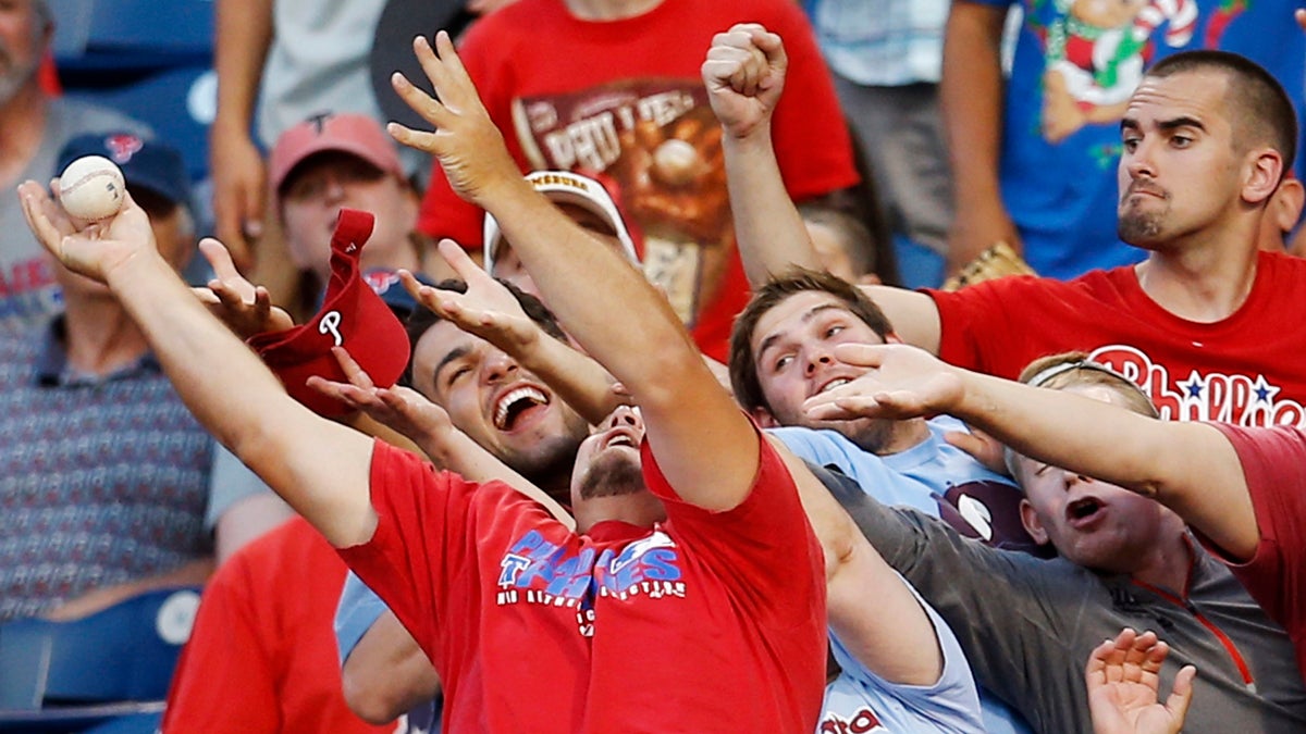  Fans reach for a foul ball hit by Philadelphia Phillies' Marlon Byrd during the third inning of a baseball game against the Miami Marlins, Tuesday, June 24, 2014, in Philadelphia. (Matt Slocum/AP Photo) 