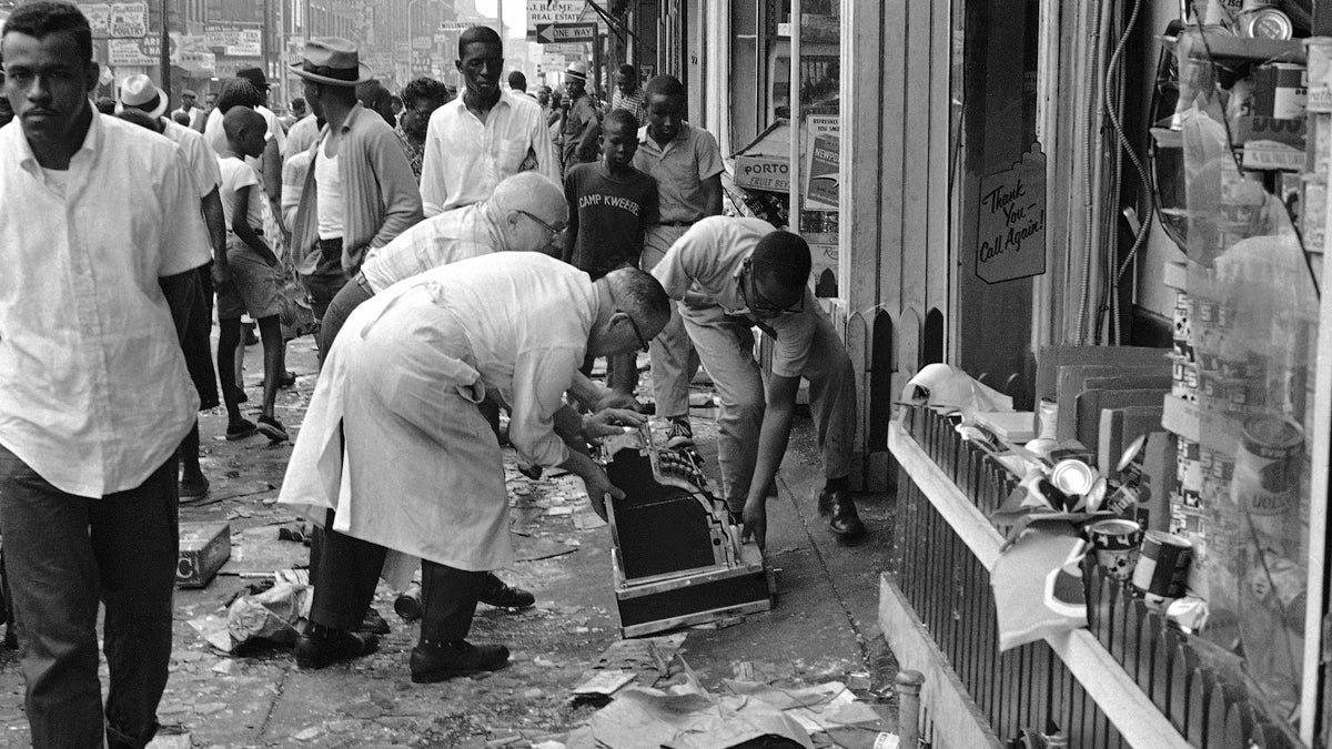 Philadelphia Race Riot 1964 Workmen pick a cash register off the sidewalk in front of smashed store, Aug. 29, 1964, wrecked during wild night of looting and rioting in North Philadelphia. Rioting that ended in injuries to scores and widespread property damage apparently began in scuffle during a routine arrest. (John F. Urwiller/AP Photo)