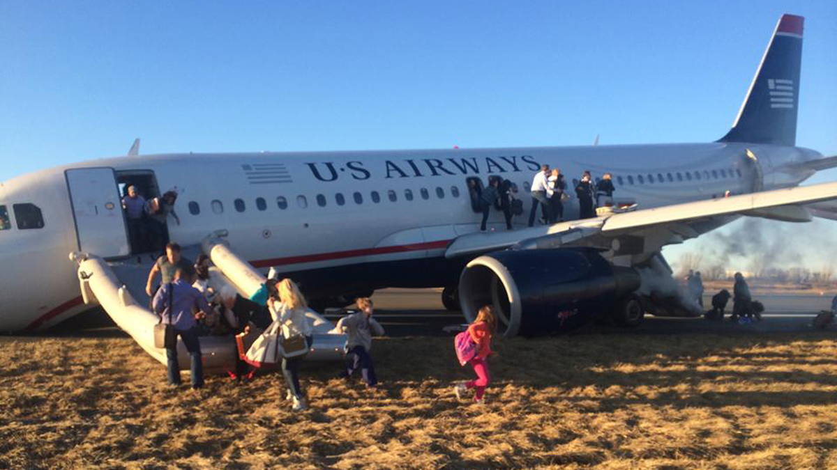  Passengers evacuate US Airways Flight 1702 after the pilot was forced to abort takeoff shortly after 6 p.m., after a tire on the plane's front landing gear blew out, Thursday, March 13, 2014, in Philadelphia. The Airbus A320 jet, bound for Fort Lauderdale, Fla., was carrying 149 passengers and five crew members, airport spokeswoman Victoria Lupica said. All were rescheduled on departing flights Thursday night, she said. (Dennis Fee/AP Photo) 