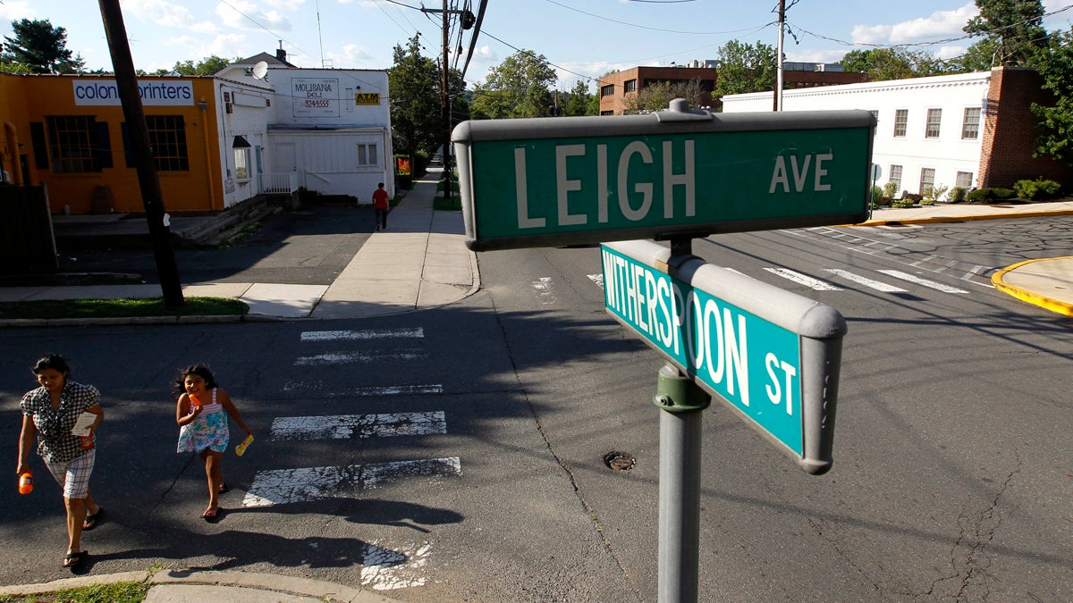  In this Aug. 11, 2011 photo, Rosalia Noyola, left, walks with her daughter Brissa Bautista, 7, near the intersection of Leigh Avenue and Witherspoon Street in Princeton, N.J. According to officials, Leigh Avenue is a good place to see how residents are divided geographically by a diagonal border that separates the Borough of Princeton and Princeton Township. Residents voted to merge. For years, governors have pushed municipal consolidation which shows just how hard it is to get New Jerseyans to make such a change. (AP Photo/Julio Cortez) 