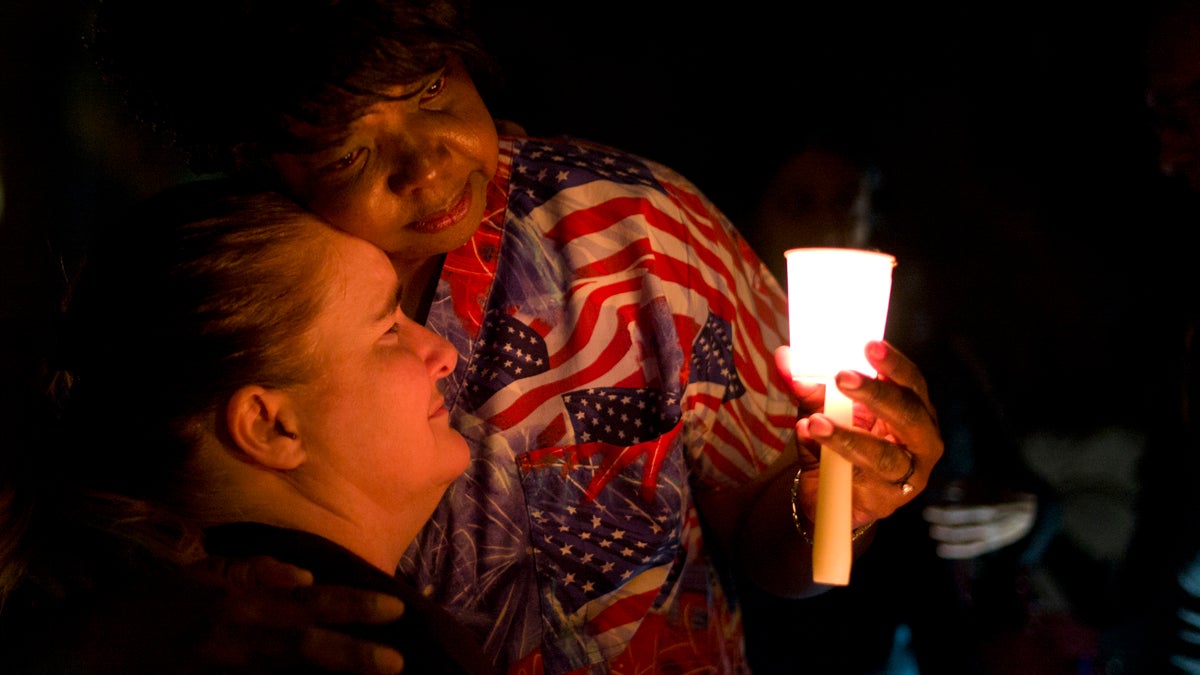  Lisa Hamons, front, a social worker for San Bernardino County, is hugged by Yolanda Richardson during a candlelight vigil for shooting victims  in San Bernardino, Calif. (Jae C. Hong/AP Photo) 