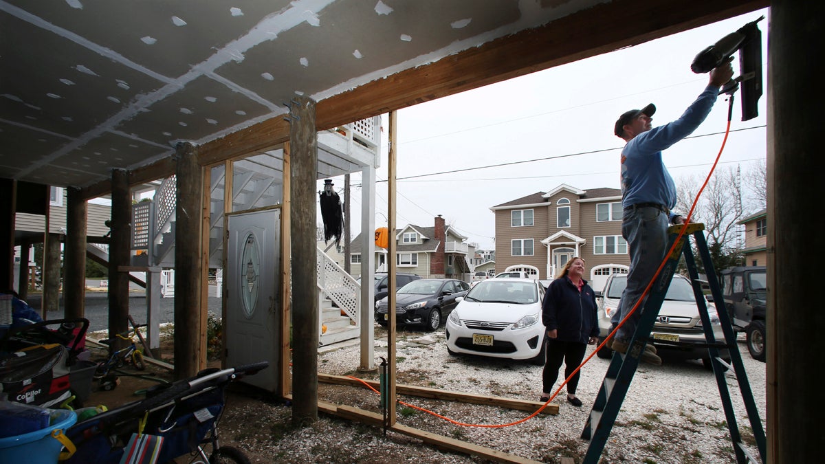  On Tuesday, while wife Dawn Markoski stands by, Stanley 'Sonny' Markoski works on their home that has been raised since being damaged, with about 27 inches of water in their house during Superstorm Sandy, in Long Beach Township, N.J. When FEMA announced that it would review Sandy-related claims to see if errors were made, the Markoskis submitted an application. The review concluded that they were owed an additional $55,972 in insurance money, nearly double what they had originally been paid. (Mel Evans/AP Photo) 