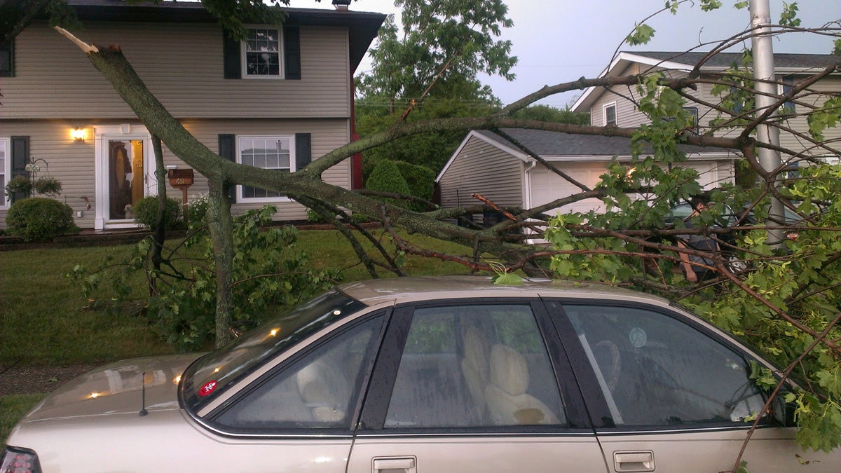  Part of a tree lies on a car after the branch broke off a tree during storms in Levittown, Pa., Thursday, July 3, 2014. Powerful thunderstorms moving across Pennsylvania have left about 171,000 customers without power. (Bob Lentz/AP Photo) 