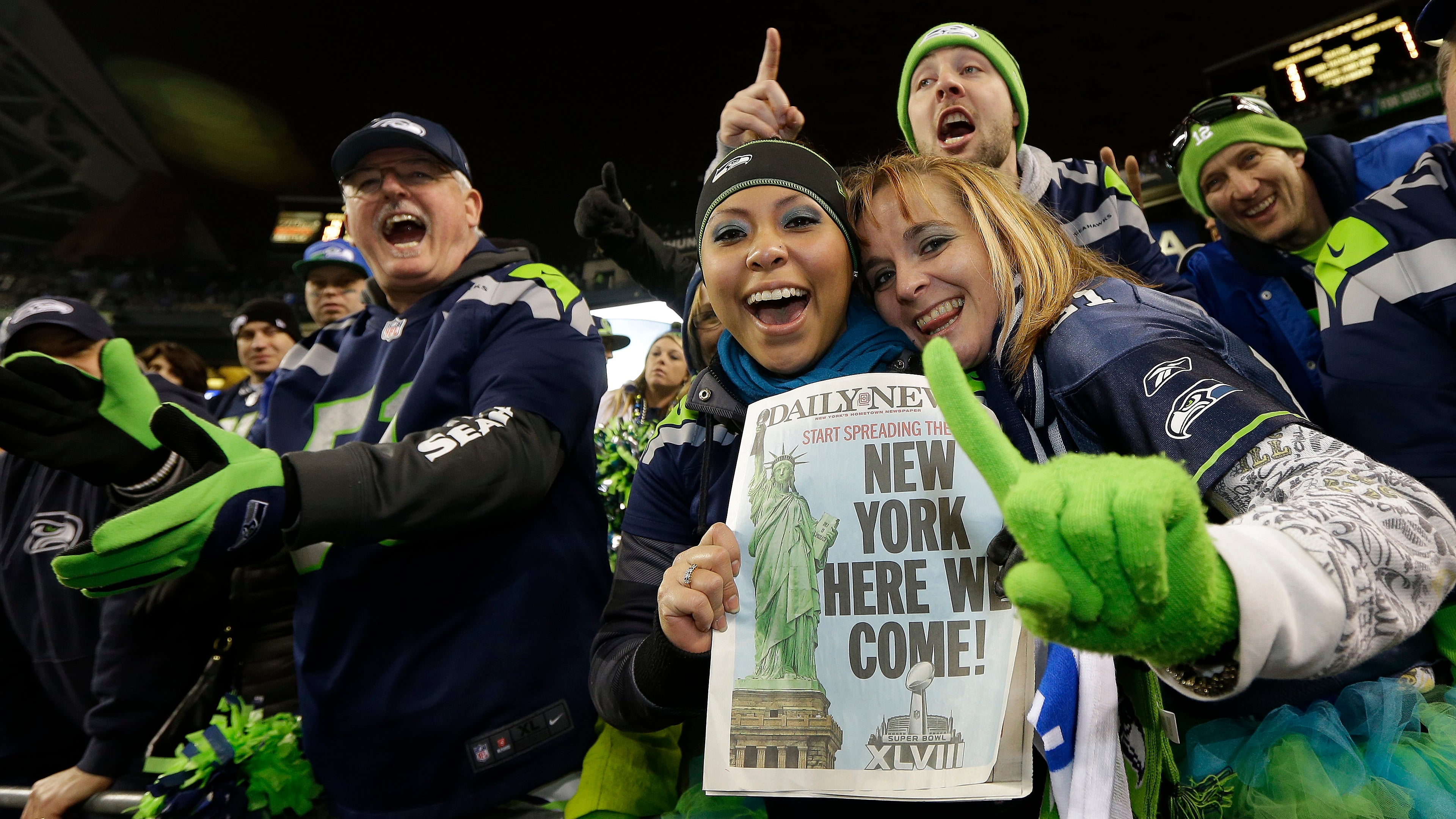  Seattle Seahawks fans celebrate after the NFL football NFC Championship game against the San Francisco 49ers Sunday, Jan. 19, 2014, in Seattle. The Seahawks won 23-17 to advance to Super Bowl XLVIII. (Ted S. Warren/AP Photo) 
