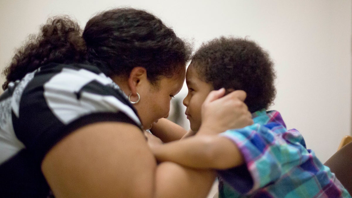  A mother plays with her 5-year-old son after he fed himself during a session in the pediatric feeding disorder program at the Marcus Autism Center in Atlanta in this 2013 photo. (David Goldman/AP Photo, file) 