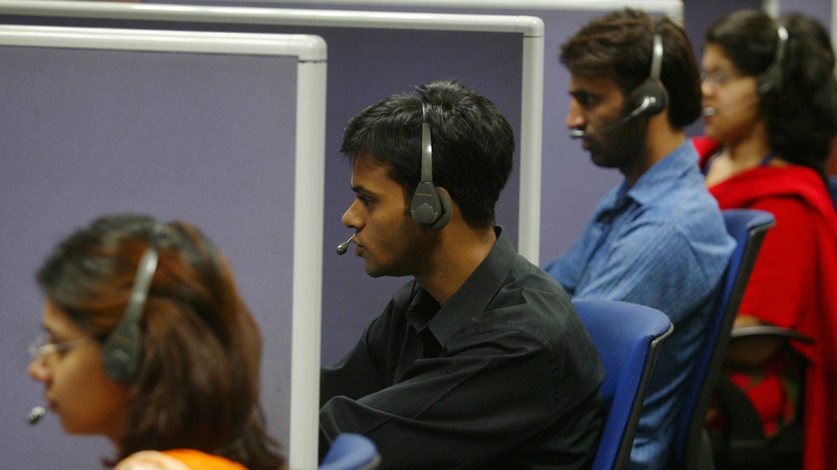  Employees answer calls at a call center (Gautam Singh/AP Photo, file) 