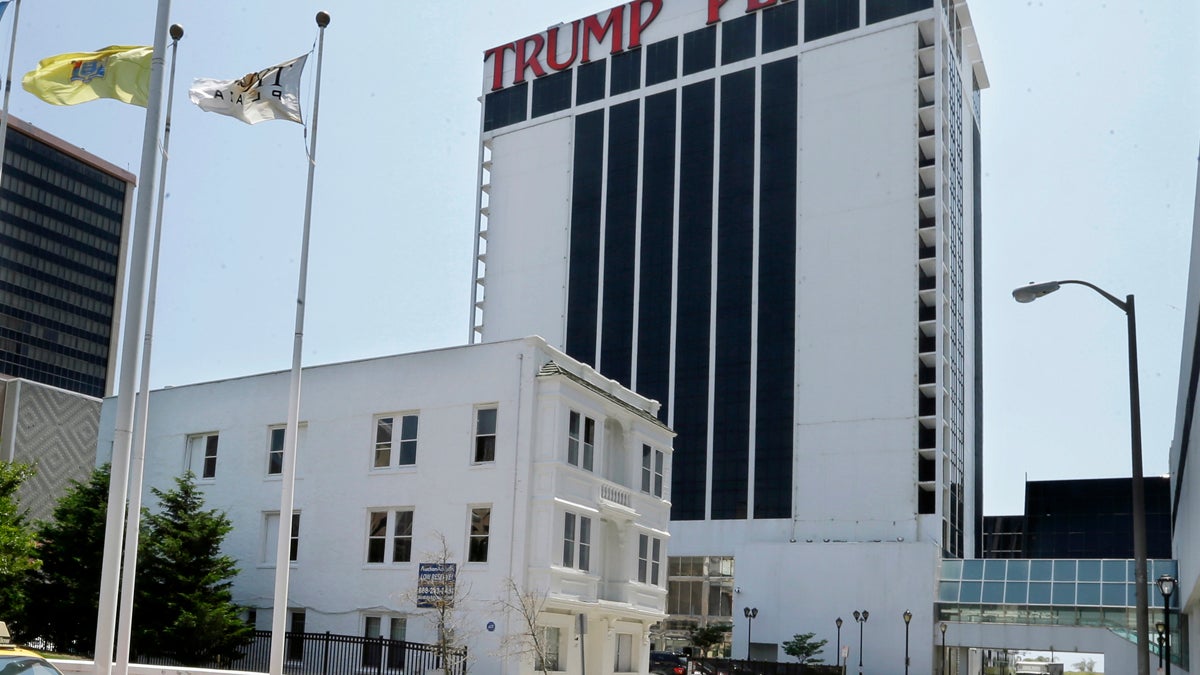  Trump Plaza Hotel and Casino towers over Vera Coking's three story rooming house Wednesday, July 23, 2014, in Atlantic City, N.J. The decrepit boarding home owned by the Atlantic City woman who has been turning down multi-million dollar offers for the building in the shadow of Trump Plaza since the 80’s has sold at auction. (Mel Evans/AP Photo) 