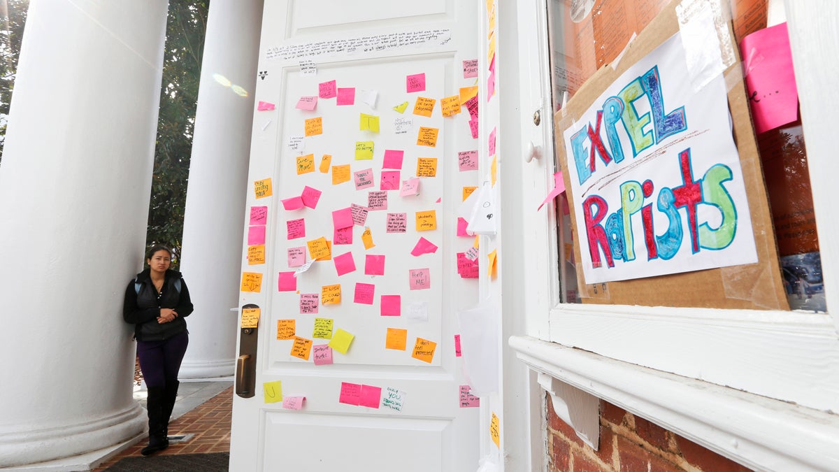  A University of Virginia student looks over postings on the door of Peabody Hall related to the Phi Kappa Psi gang rape allegations at the school in Charlottesville, Va., Monday, Nov. 24, 2014. The university has suspended activities at all campus fraternal organizations amid an investigation into a published report in which a student described being sexually assaulted by seven men in 2012 at the Phi Kappa Psi house. (Steve Helber/AP Photo) 
