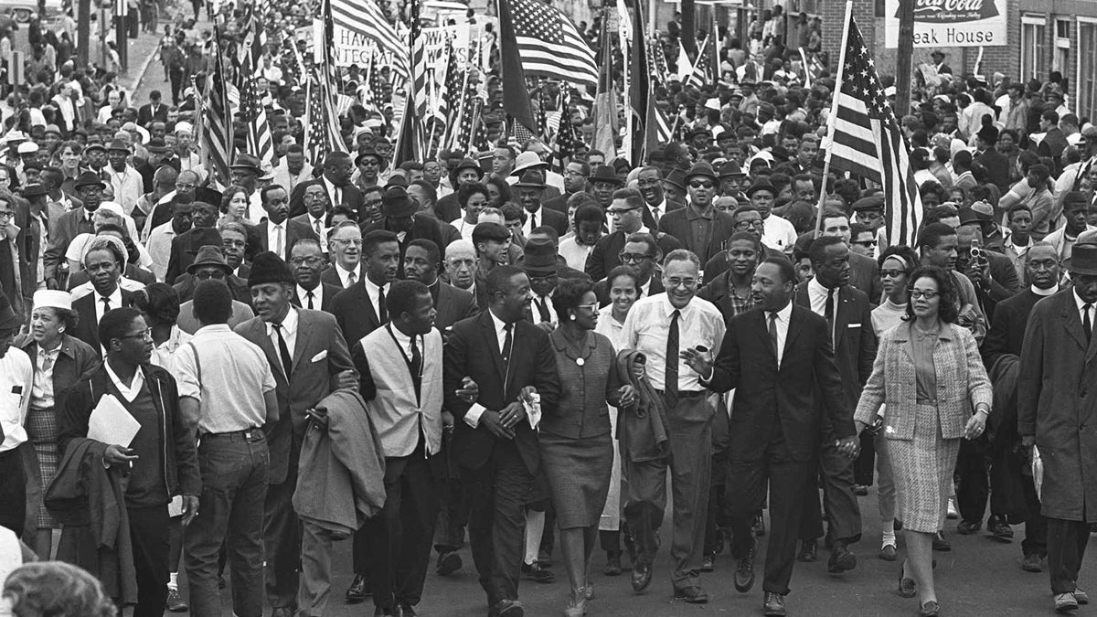  Dr. Martin Luther King, third from right, marchers across the Alabama River on the first of a five day, 50 mile march to the state capitol at Montgomery, Ala., on March 21, 1965.(AP Photo) 