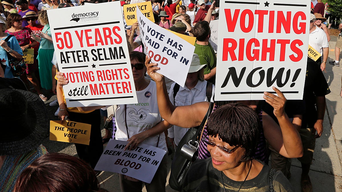  Demonstrators march through the streets of Winston-Salem, N.C., Monday, July 13, 2015, after the beginning of a federal voting rights trial challenging a 2013 state law. Election law experts say the case could determine how far Southern states can change voting rules after the nation's highest court struck down a portion of the federal Voting Rights Act just weeks before the North Carolina law was passed. (Chuck Burton/AP Photo) 