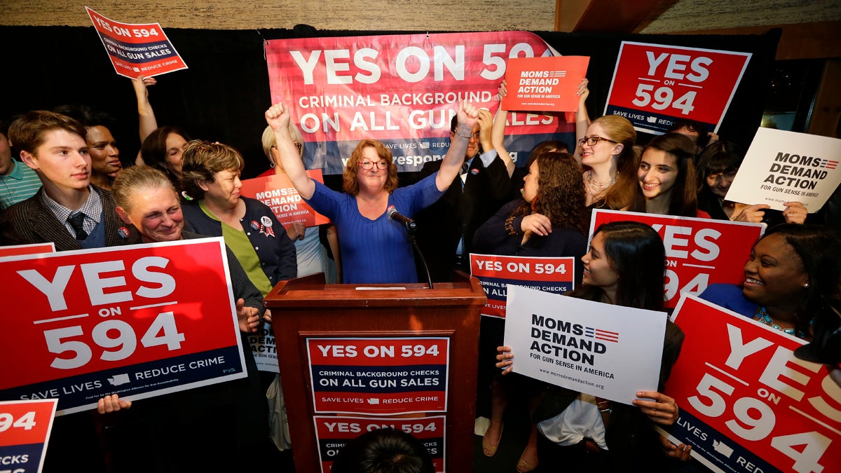  Cheryl Stumbo, (center) raises her arms as she finishes speaking at an election night party for Initiative 594, a measure seeking universal background checks on gun sales and transfers, Tuesday, Nov. 4, 2014, in Seattle. Stumbo, the citizen sponsor of the initiative, is a survivor in the shooting at the Jewish Federation in Seattle in 2006. The initiative is one of two competing gun initiatives in Washington state. The other measure, Initiative 591, would prevent any such expansion of background checks. (Elaine Thompson/AP Photo) 