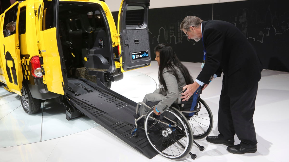  A model demonstrates the  features of a wheelchair-accessible taxi at the 2013 New York International Auto Show. (AP Photo/Mary Altaffer) 