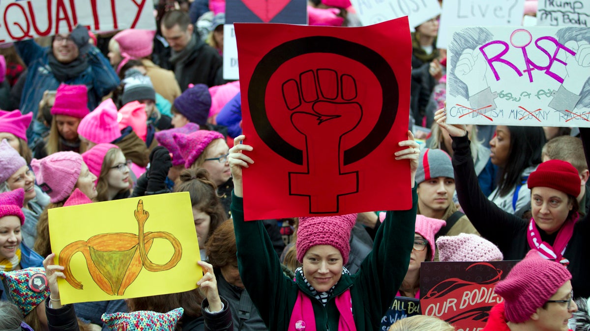 Women with bright pink hats and signs gather early and are set to make their voices heard on the first full day of Donald Trump's presidency