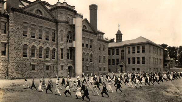 This rear view of Ardmore Avenue School shows students exercising and an enclosed spiral fire escape. (Lower Merion Historical Society Archives) 