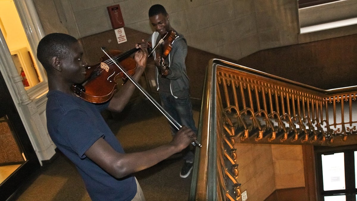  Violinist Franco Yugga and violinist Sean Bennett perform  at City Hall to advocate for arts funding on Tuesday afternoon. (Kimberly Paynter/WHYY) 