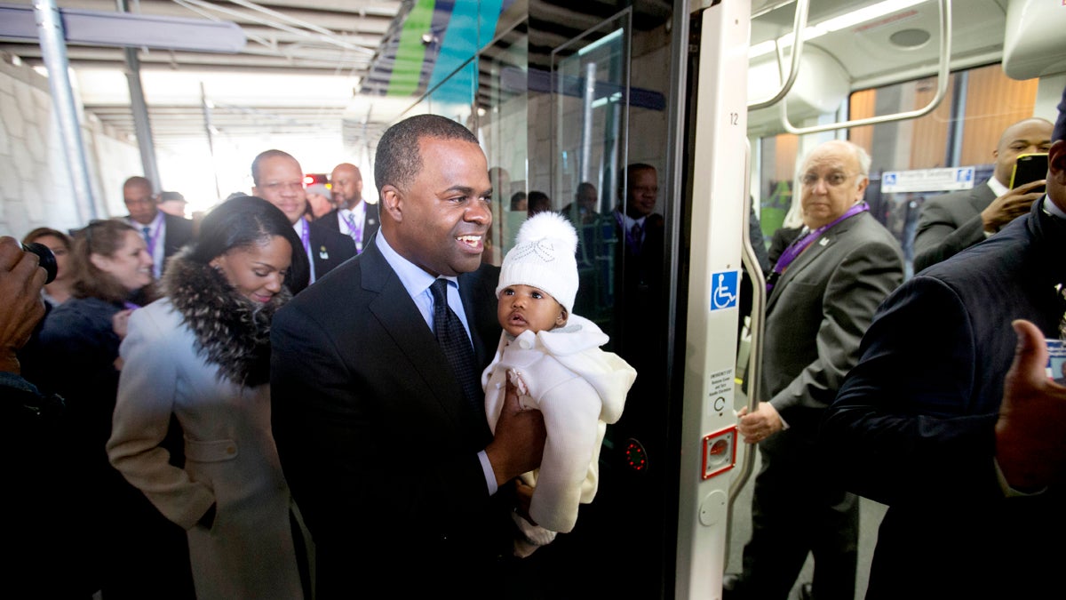  Atlanta Mayor Kasim Reed holds his six-month-old daughter Maria Kristan while boarding an Atlanta Streetcar with wife Sarah-Elizabeth, left, for its inaugural trip through downtown Atlanta in 2014. Reed says the streetcar's 2.7-mile route will connect neighbors to several tourist attractions, museums and entertainment venues. (AP Photo/David Goldman) 