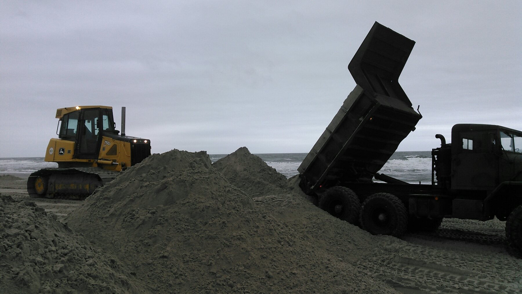 Avalon workers move sand on the beach. (Scott Wahl)