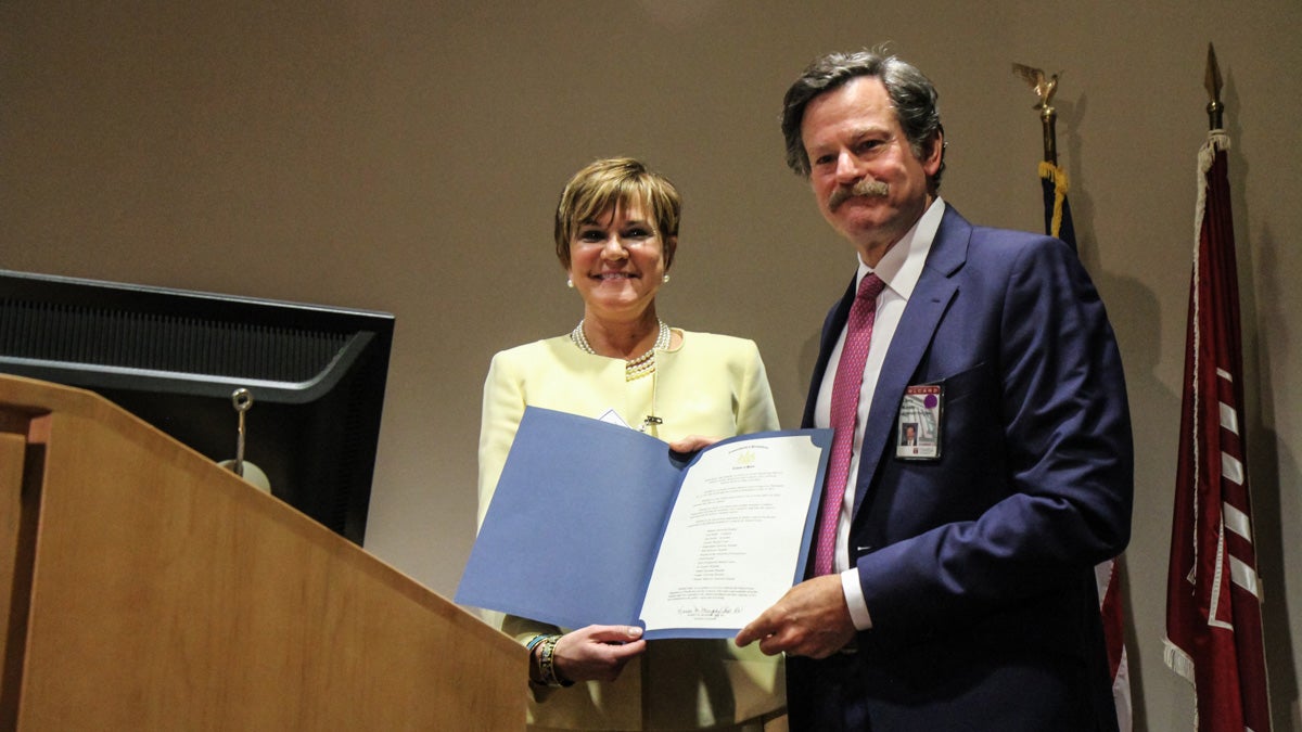 Dr. Karen Murphy, secretary of the Pennsylvania Department of Health, presents Dr. Larry Kaiser of Temple University Health System with a certificate honoring the hospitals efforts during the Amtrak train derailment on May 12. (Kimberly Paynter/WHYY) 