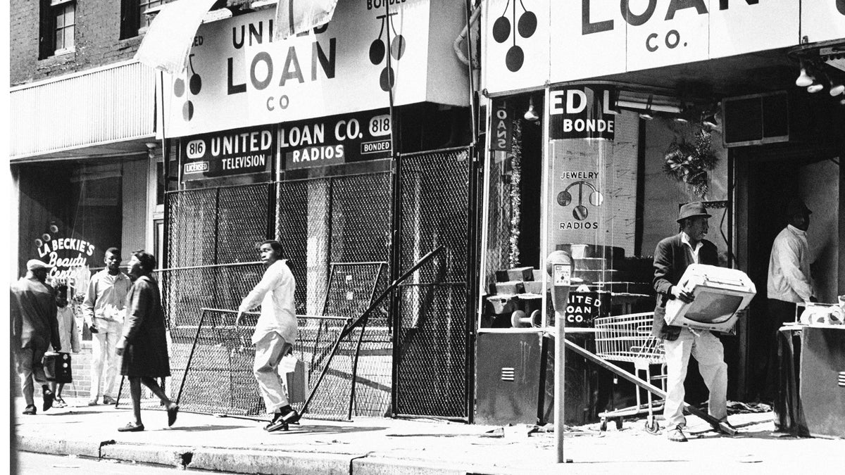  A man carts off a television set during looting incidents in Baltimore on Sunday, April 7, 1968. Many businesses were broken into, looted and burned that weekend. (AP Photo) 